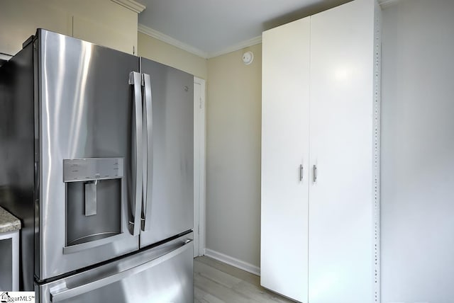 kitchen featuring light hardwood / wood-style flooring, white cabinets, stainless steel fridge with ice dispenser, and crown molding