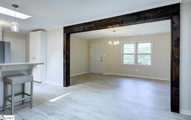 interior space with an inviting chandelier and light hardwood / wood-style flooring