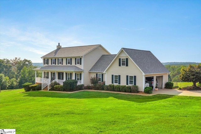 view of front facade with a porch, a garage, and a front yard