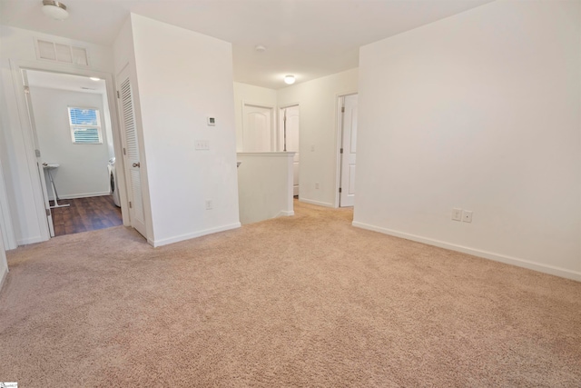 unfurnished room with carpet flooring and washer / dryer