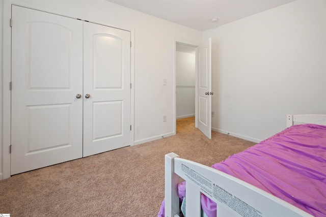 carpeted bedroom with a closet