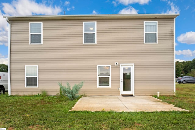 back of house featuring a yard and a patio area