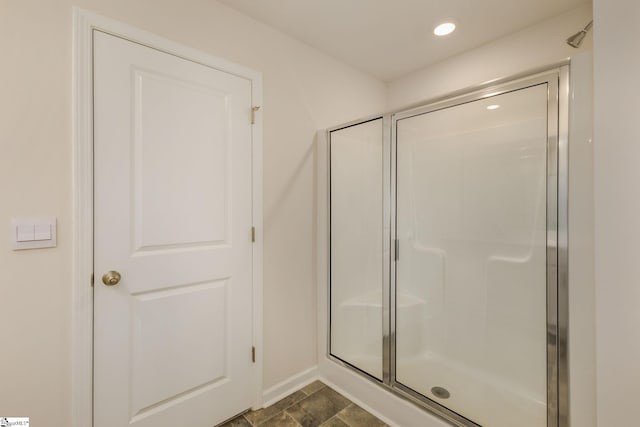 bathroom featuring a shower with door