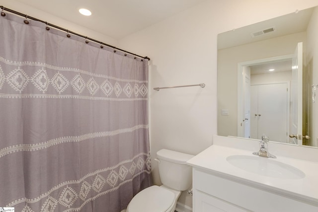 bathroom with vanity, toilet, and curtained shower