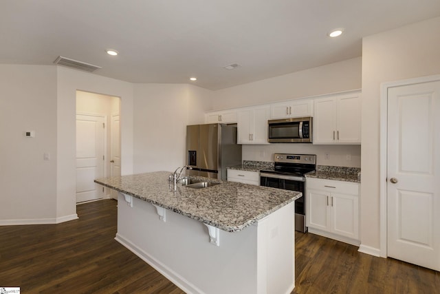 kitchen with white cabinets, sink, a kitchen island with sink, appliances with stainless steel finishes, and dark hardwood / wood-style floors