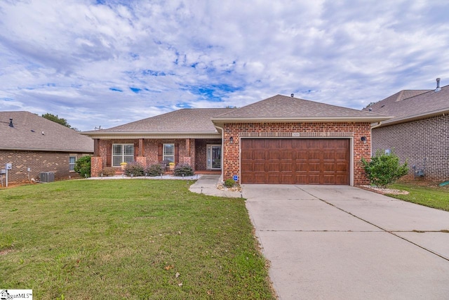 ranch-style house featuring cooling unit, a garage, and a front lawn