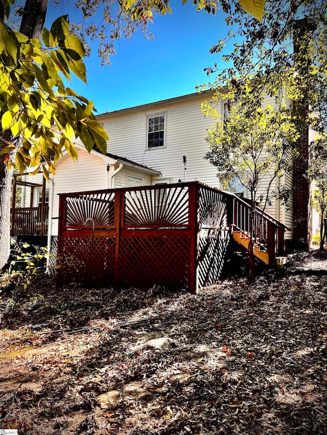 rear view of house with a wooden deck