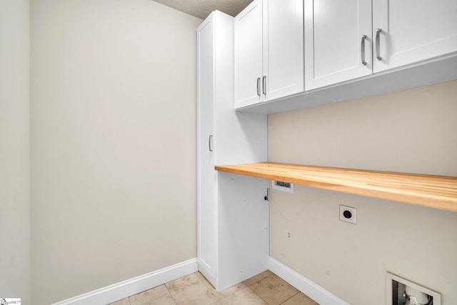 washroom featuring washer hookup, cabinets, light tile patterned floors, and electric dryer hookup