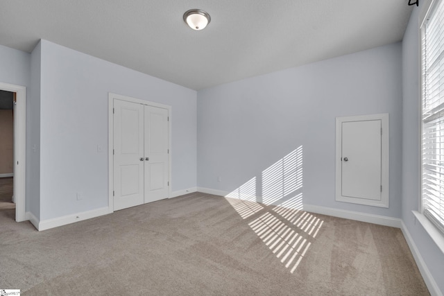 empty room featuring light carpet and plenty of natural light