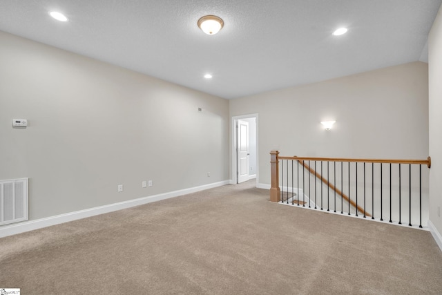 spare room featuring light colored carpet