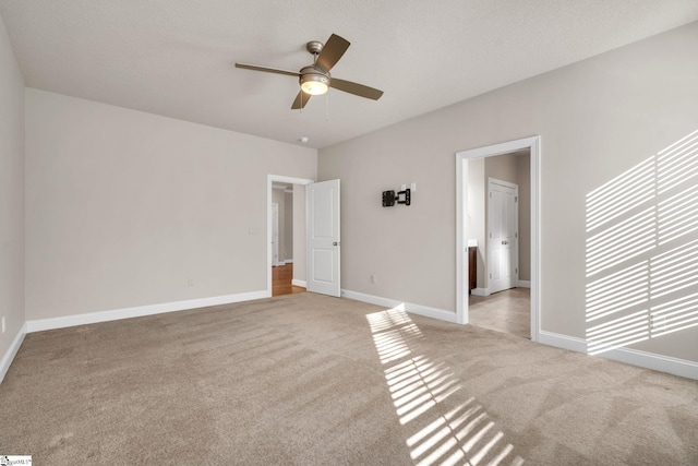 unfurnished bedroom with ceiling fan, a textured ceiling, and light carpet