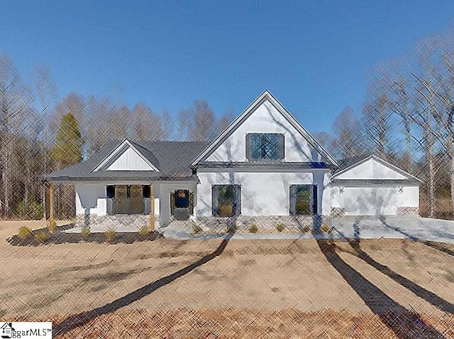 modern farmhouse style home with a garage and covered porch