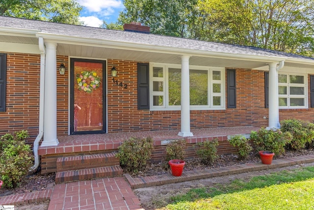 property entrance with covered porch