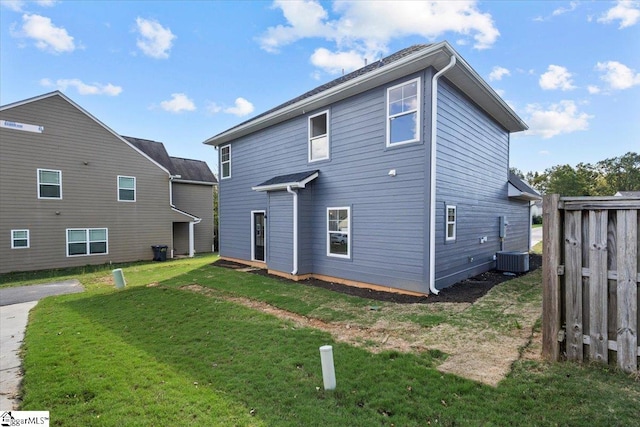 rear view of house with a yard