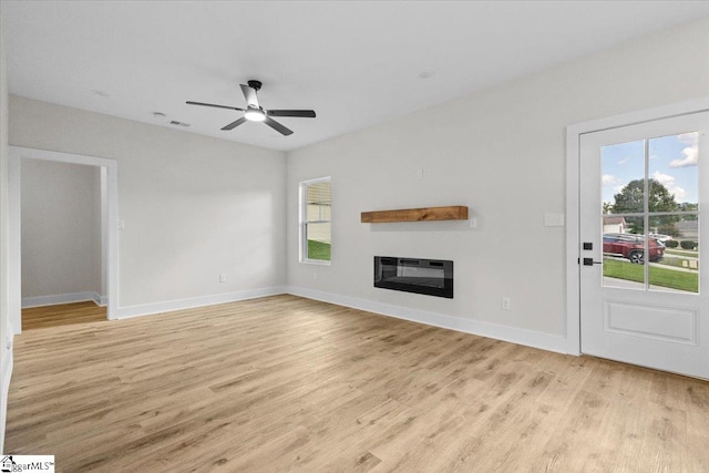 unfurnished living room with ceiling fan and light wood-type flooring