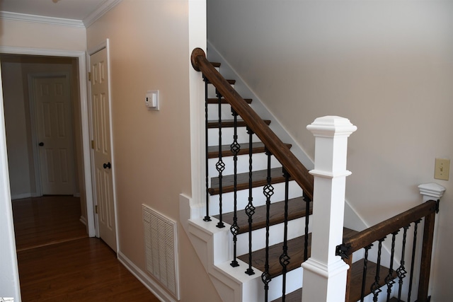 staircase featuring ornamental molding and wood-type flooring