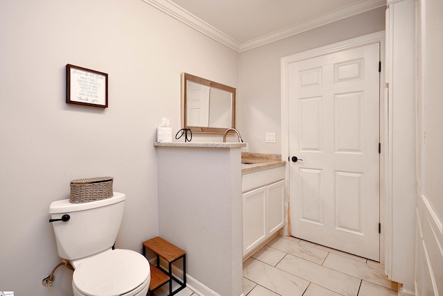 bathroom with crown molding, vanity, and toilet