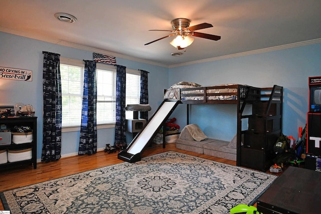 bedroom with ceiling fan, hardwood / wood-style flooring, and ornamental molding