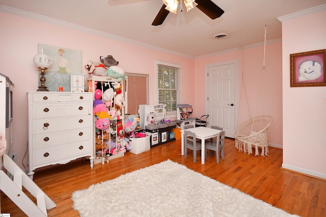 game room with ceiling fan, hardwood / wood-style floors, and crown molding