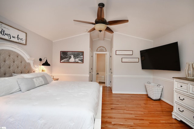 bedroom with ceiling fan, light wood-type flooring, and vaulted ceiling