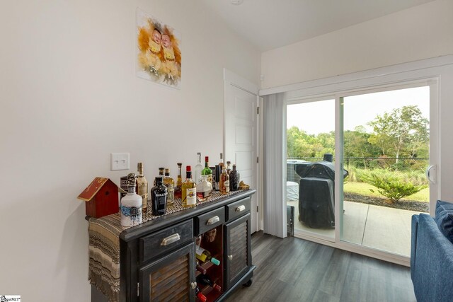 bar with dark hardwood / wood-style flooring