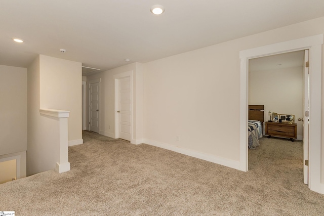 unfurnished room with light colored carpet