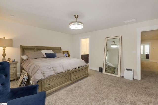 carpeted bedroom with connected bathroom