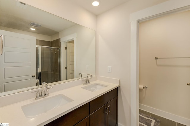 bathroom featuring vanity, tile patterned floors, and a shower with door