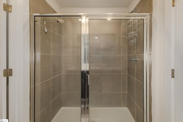 bathroom with a shower with door