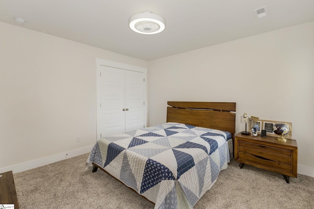 bedroom with light carpet and a closet