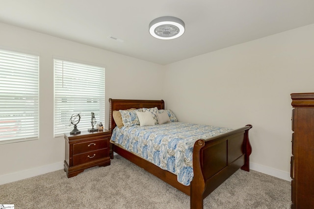 bedroom featuring light carpet