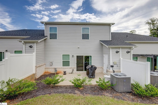 back of property with cooling unit and a patio area