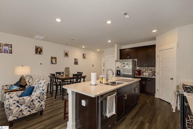 kitchen with a center island with sink, sink, stainless steel appliances, and dark hardwood / wood-style flooring