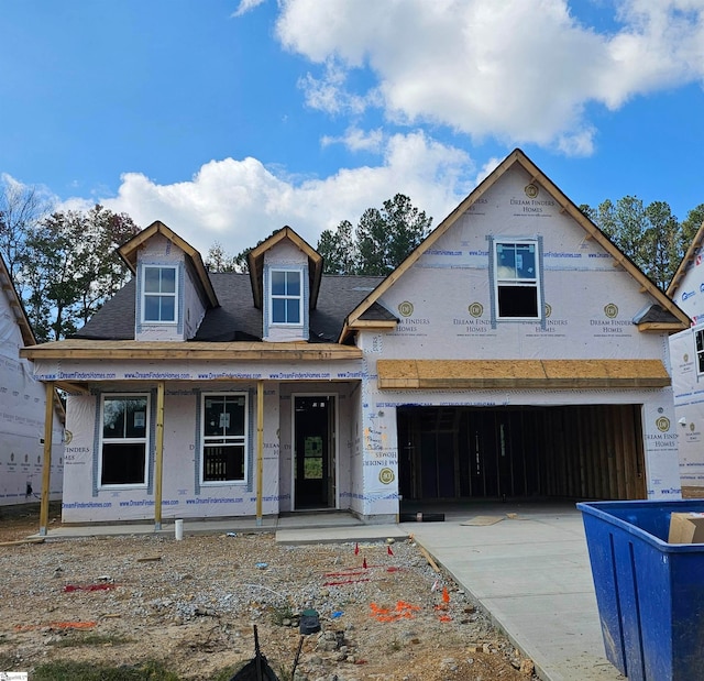 property under construction featuring a garage and covered porch