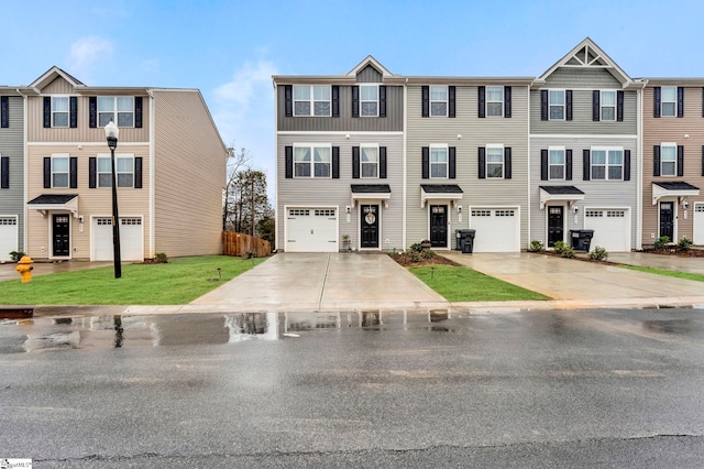 multi unit property featuring a front yard and a garage