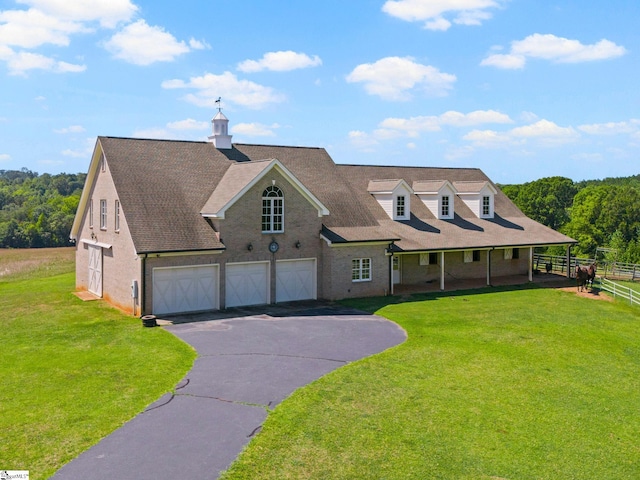 view of front of property with a garage and a front yard