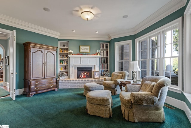 living room with crown molding, carpet, and a fireplace