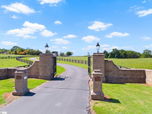 view of home's community with a rural view and a yard