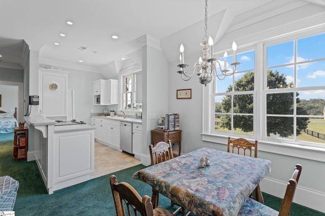 dining room featuring light colored carpet, lofted ceiling, crown molding, and a chandelier