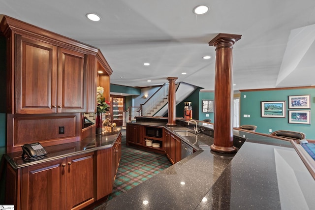 bar featuring sink, black microwave, crown molding, dark stone countertops, and ornate columns