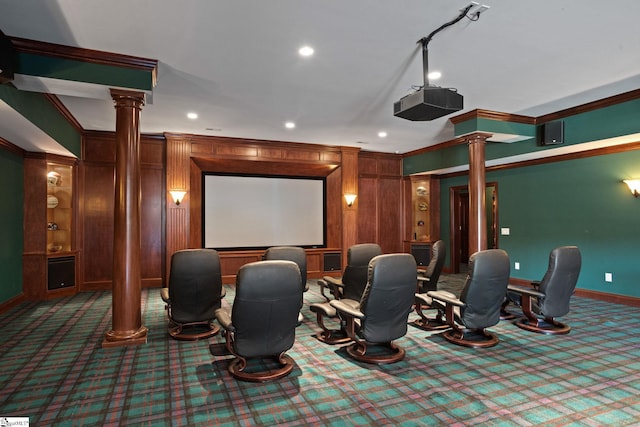 cinema room featuring ornamental molding, decorative columns, and carpet floors