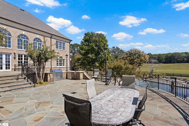 view of patio with area for grilling and an outdoor kitchen