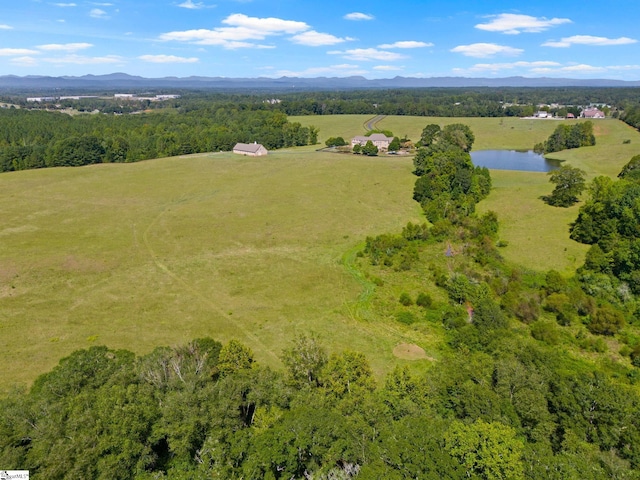 drone / aerial view featuring a rural view and a water and mountain view