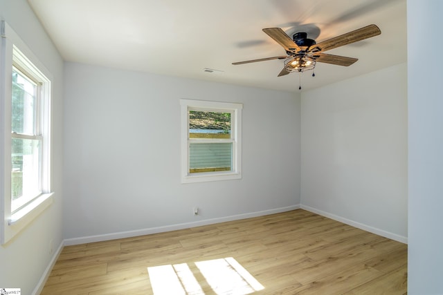 spare room featuring light hardwood / wood-style floors and ceiling fan