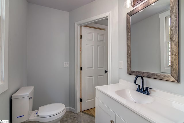 bathroom featuring vanity, toilet, and tile patterned floors