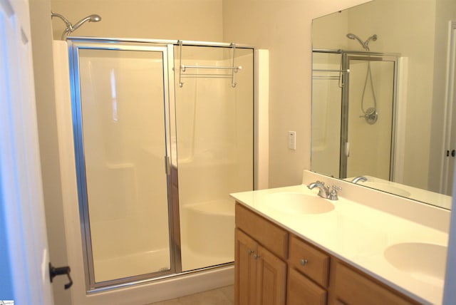 bathroom with vanity, a shower with door, and tile patterned floors