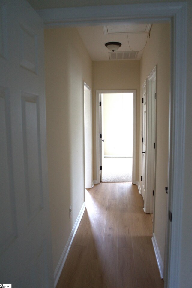 hall with light hardwood / wood-style floors