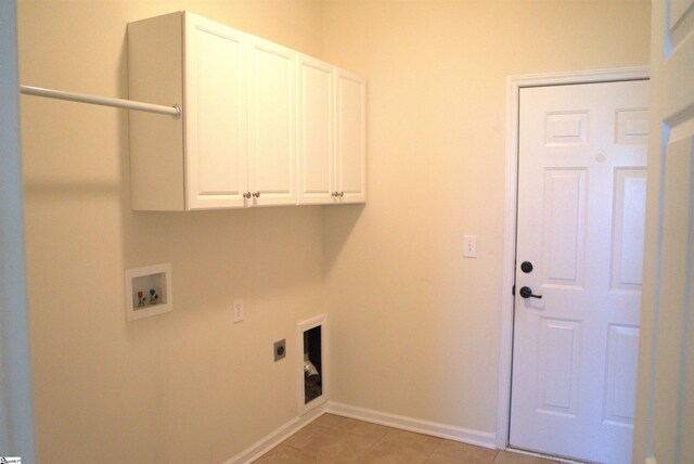 laundry room with cabinets, electric dryer hookup, hookup for a washing machine, and light tile patterned floors