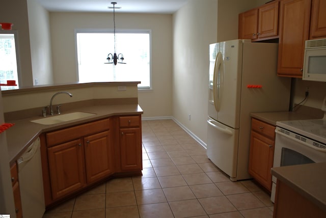 kitchen featuring a chandelier, sink, hanging light fixtures, white appliances, and light tile patterned floors