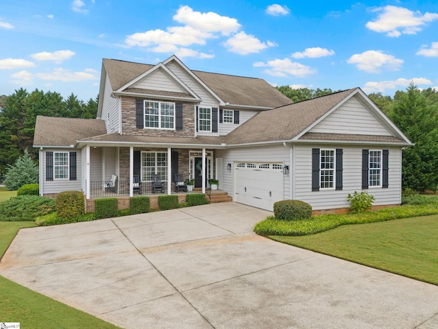 view of front of house featuring covered porch, a front yard, and a garage